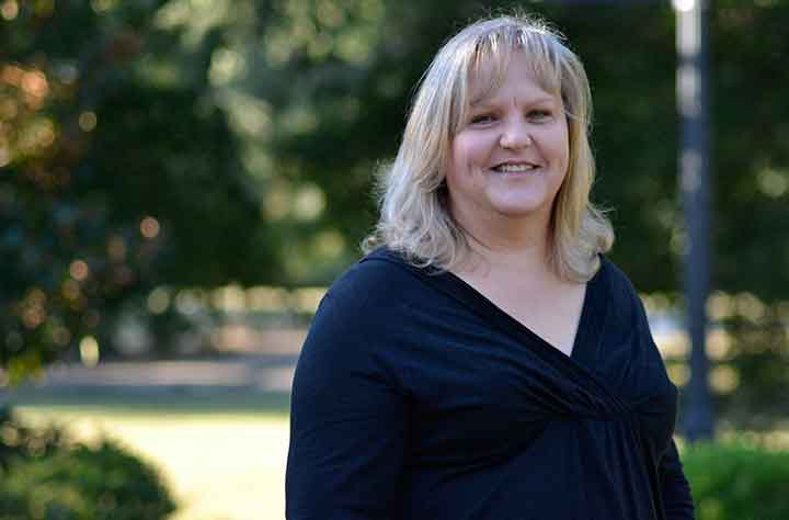 Professor Marsha Roberts stands outside Munroe Science Center