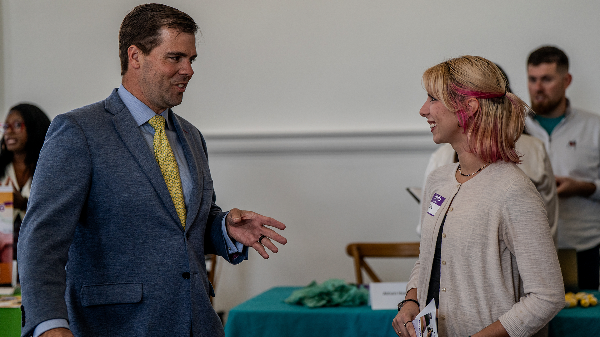 Female student engaging in conversation with businessman