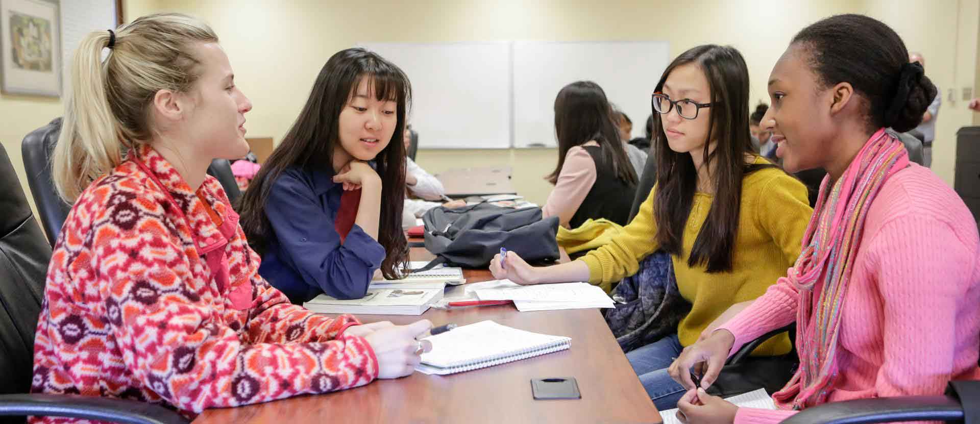 Students sitting at a table and talking