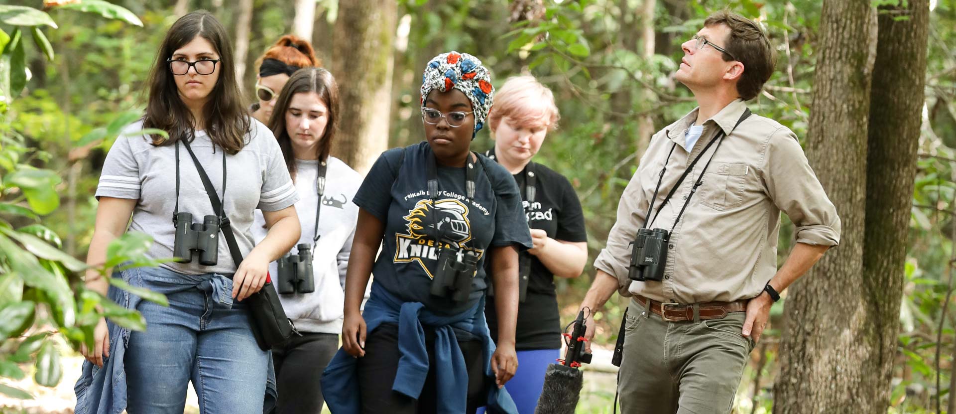 Students and professor explore in the Arboretum.