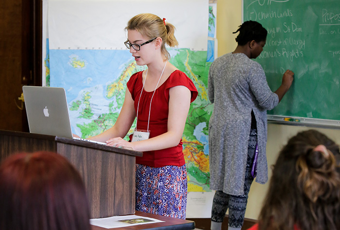 History student presents work to classroom