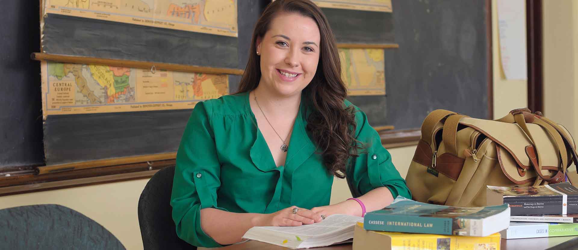 International Relations student smiles at the camera in a Tate classroom